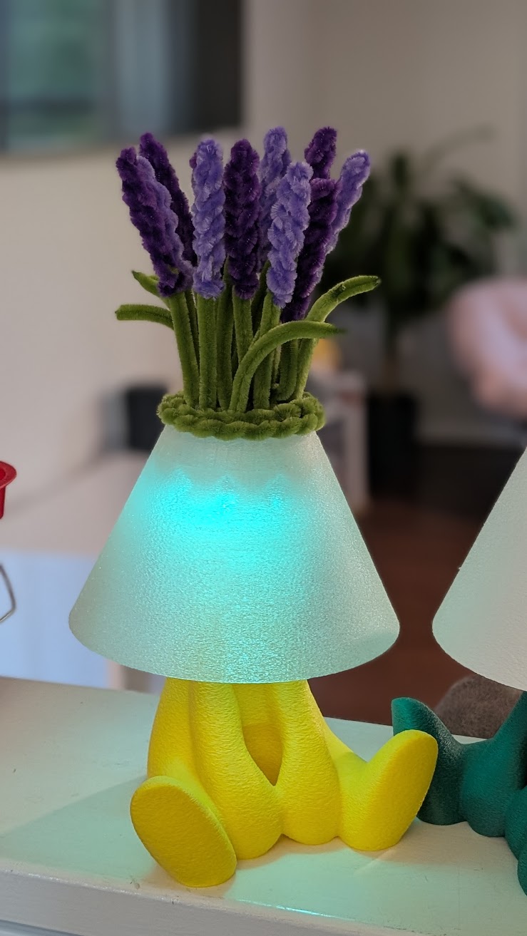 Yellow lamp with purple lavender pipe cleaner flowers glowing teal